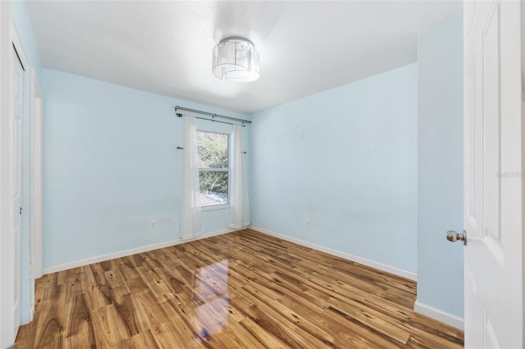 5073 Southwest 40th Place Ocala, FL 34474 - Photo 38 of 53 a view of empty room with wooden floor