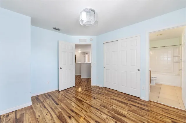 a view of a bedroom with wooden floor and bedroom