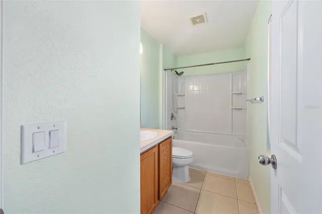 a view of a room with a wooden floor and a ceiling fan