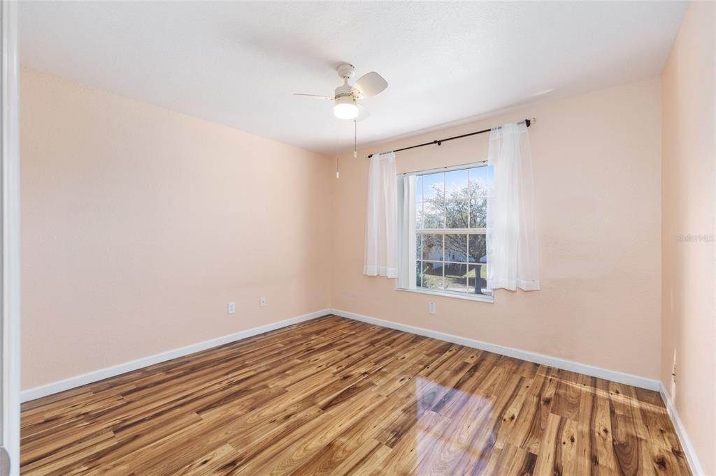 5073 Southwest 40th Place Ocala, FL 34474 - Photo 44 of 53 a view of an empty room with wooden floor and a window
