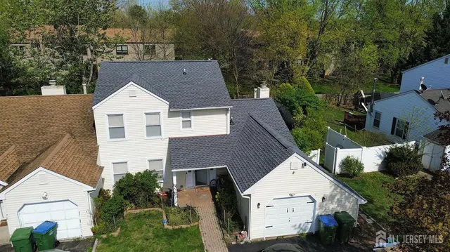 an aerial view of a house with a yard