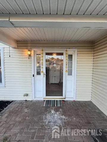 a view of a house with a door and wooden floor