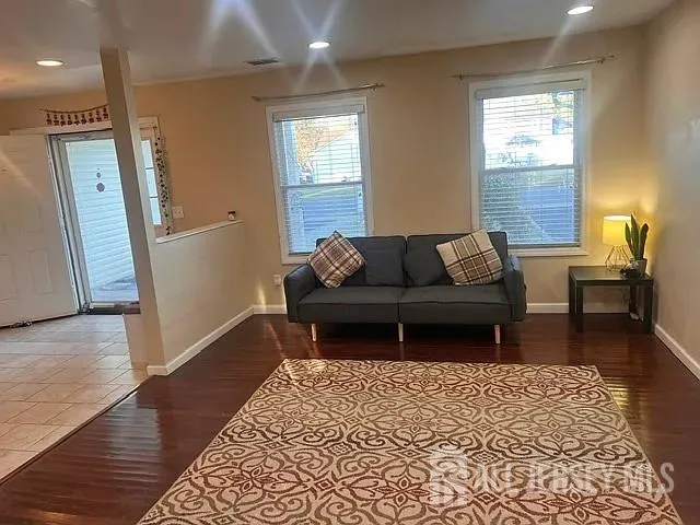 a view of a room with furniture and wooden floor
