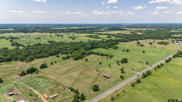 a view of a field with an ocean view