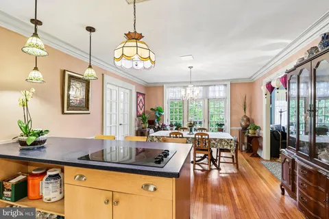 a very nice looking living room with a large window and wooden floor