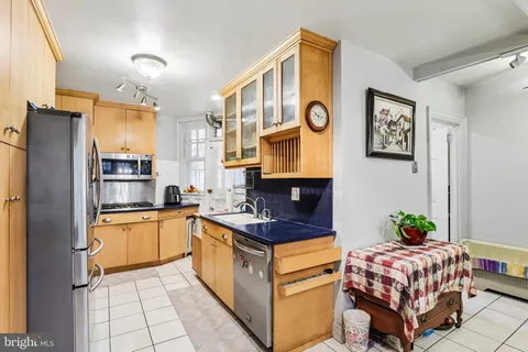 a kitchen with stainless steel appliances granite countertop a refrigerator and a sink