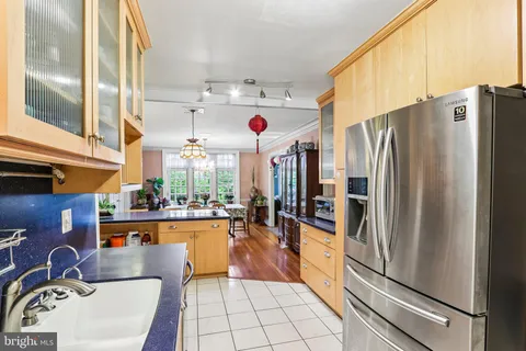 a kitchen with granite countertop a sink appliances and cabinets