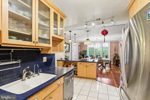 a kitchen with a refrigerator and a stove top oven