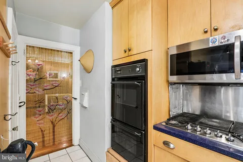 a kitchen with stainless steel appliances kitchen island granite countertop a refrigerator and a stove