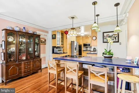 a very nice looking dining room with a table or chandelier and wooden floor