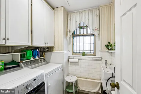a bathroom with a bathtub sink and window