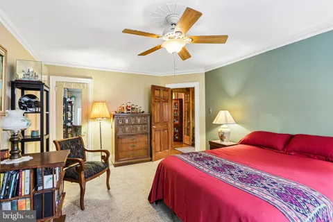 a view of a bedroom with furniture and a window