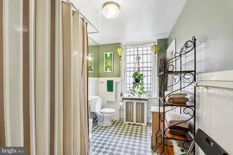 a bathroom with a sink toilet and a mirror