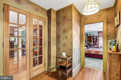 a bed sitting in a bedroom next to a window
