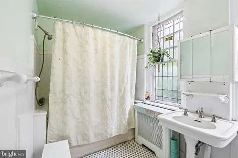 a bathroom with a sink toilet a mirror and shower