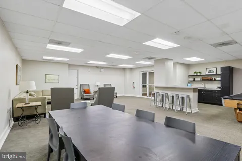 a room with table chairs and white walls