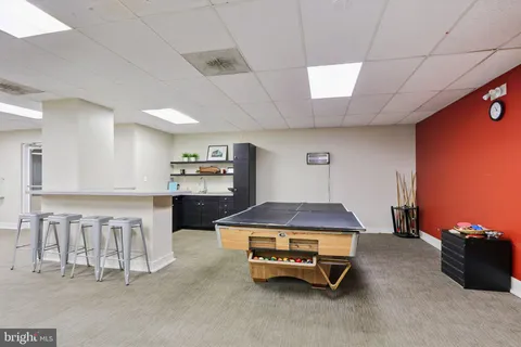 a lobby with furniture and a large mirror