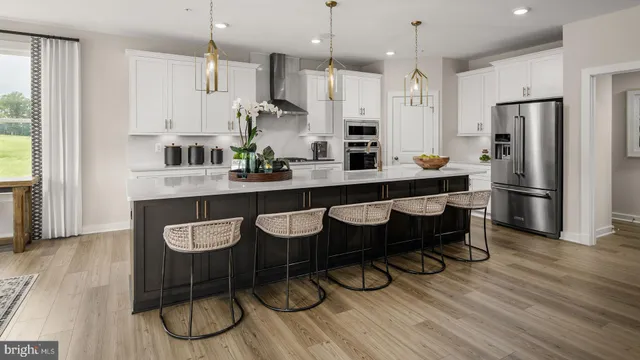 a large kitchen with a table and chairs