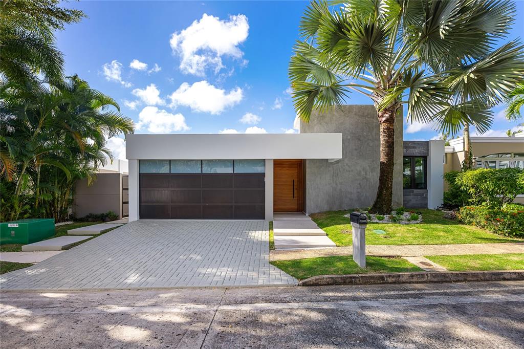 373 Guaynabo Prairie Guaynabo, PR 00969 - Photo 1 of 17 a front view of a house with garage and yard