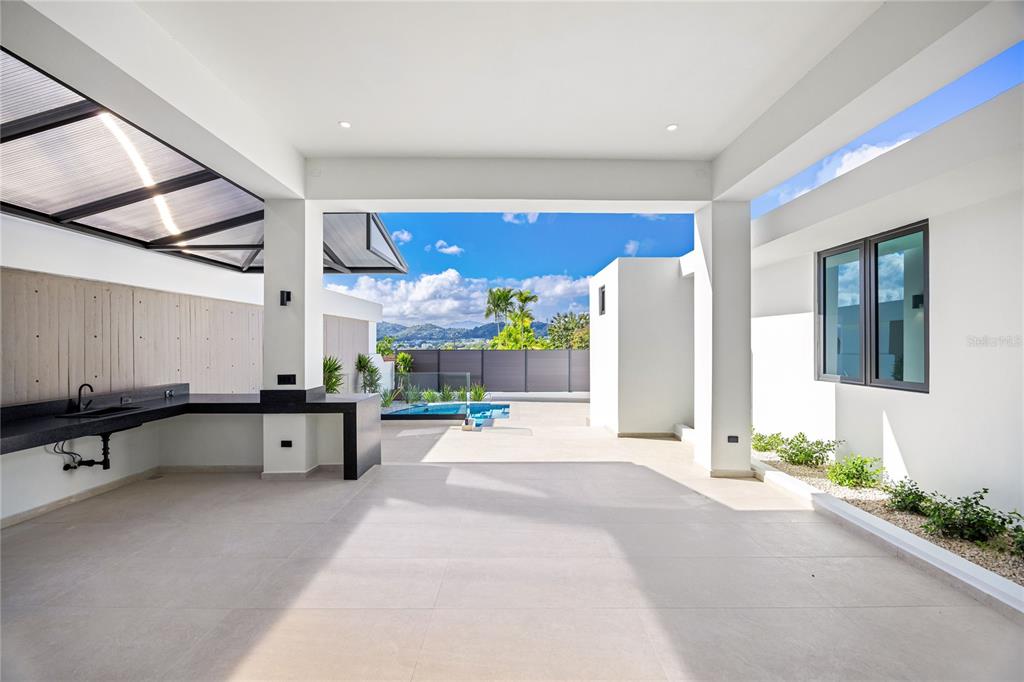 373 Guaynabo Prairie Guaynabo, PR 00969 - Photo 12 of 17 a large white building with glass door and furniture