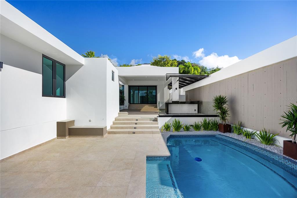373 Guaynabo Prairie Guaynabo, PR 00969 - Photo 15 of 17 a front view of a house with potted plants
