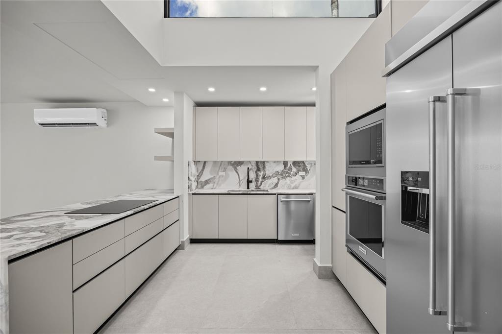 373 Guaynabo Prairie Guaynabo, PR 00969 - Photo 6 of 17 a kitchen with granite countertop white cabinets and stainless steel appliances