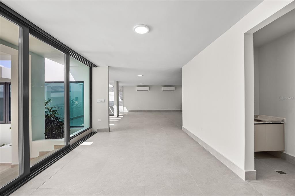 373 Guaynabo Prairie Guaynabo, PR 00969 - Photo 10 of 17 a view of a big room with windows and entryway
