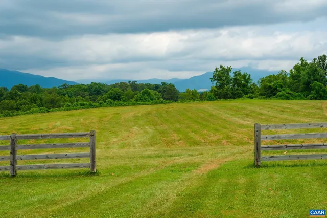 a view of a big yard with lots of green space and mountain view