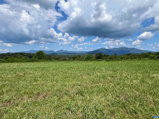 a view of field with trees in the background