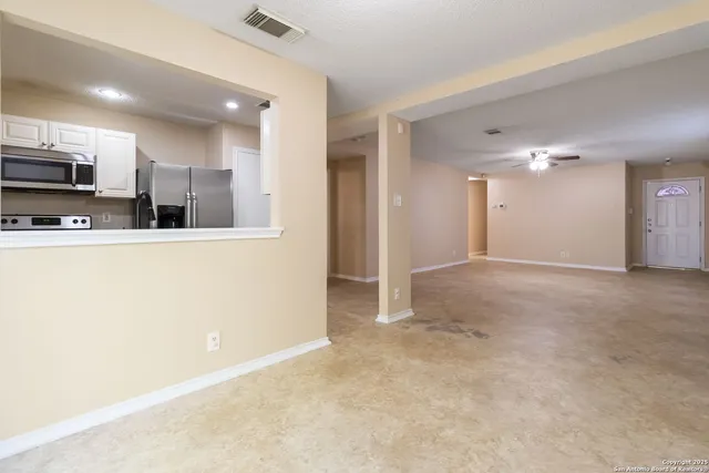 a view of a kitchen with a sink and a refrigerator