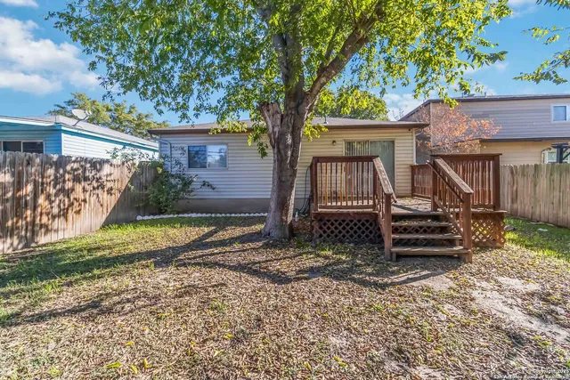 front view of a house with a tree in the yard