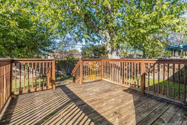 a balcony with wooden floor and fence
