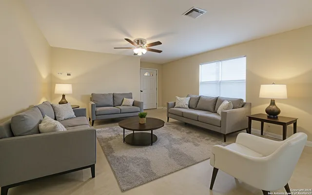 a living room with furniture and a chandelier