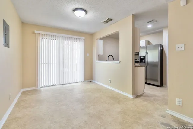 an empty room with closet and a bathroom