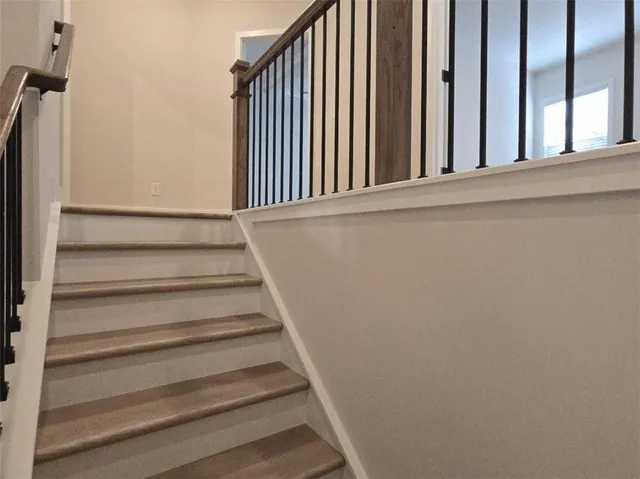 a view of staircase with rug