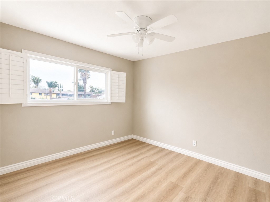 1118 West Orange Road Santa Ana, CA 92706 - Photo 11 of 18 an empty room with wooden floor and windows