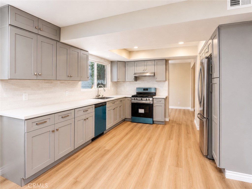 1118 West Orange Road Santa Ana, CA 92706 - Photo 2 of 18 a kitchen with stainless steel appliances granite countertop a sink dishwasher stove and refrigerator