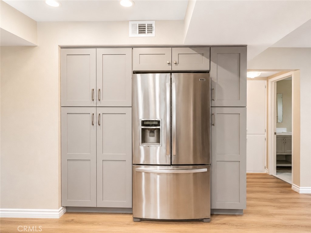 1118 West Orange Road Santa Ana, CA 92706 - Photo 3 of 18 a white refrigerator freezer and a wooden floor