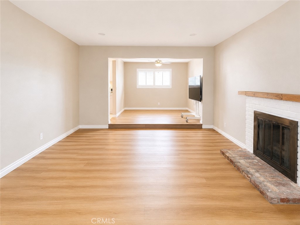 1118 West Orange Road Santa Ana, CA 92706 - Photo 5 of 18 a view of an empty room with wooden floor and a window