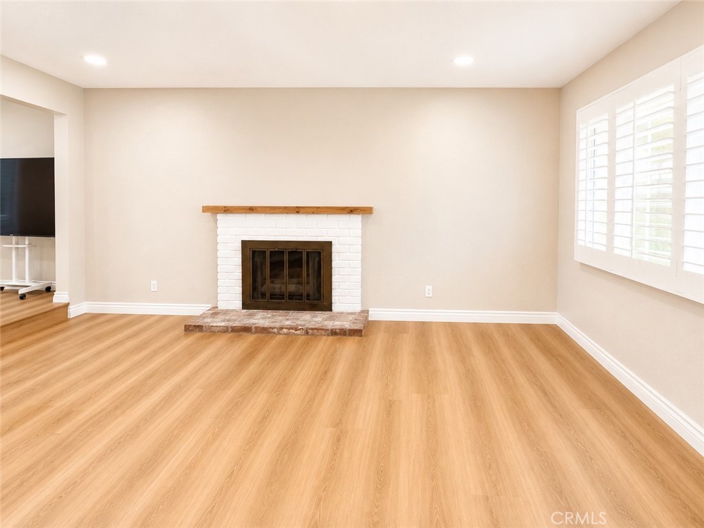 1118 West Orange Road Santa Ana, CA 92706 - Photo 6 of 18 a view of an empty room with a fireplace and a window