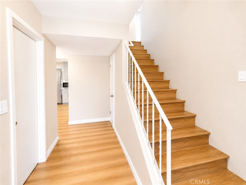 1118 West Orange Road Santa Ana, CA 92706 - Photo 7 of 18 a view of a hallway with wooden floor and entryway