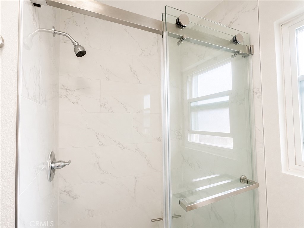 1118 West Orange Road Santa Ana, CA 92706 - Photo 10 of 18 a bathroom with a glass shower door