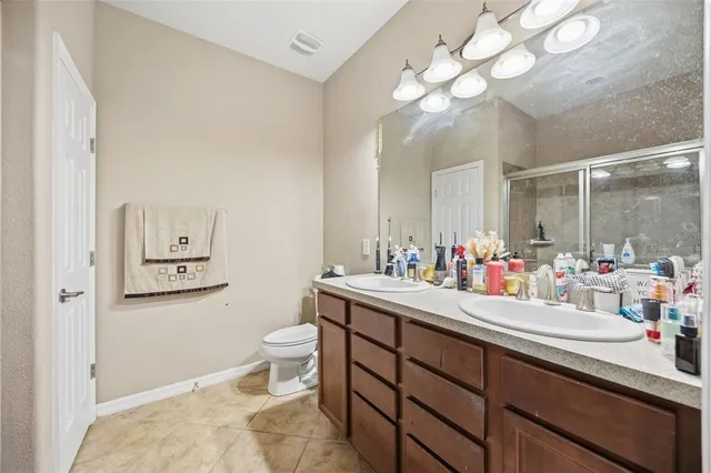 a bathroom with a sink vanity mirror and toilet