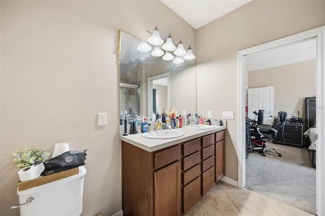 a bathroom with a sink vanity and mirror