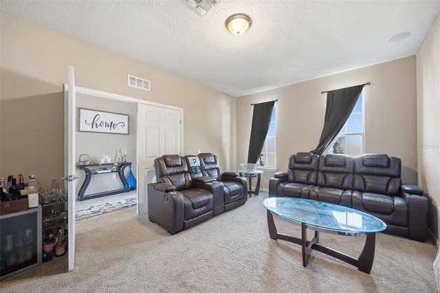 a living room with furniture and a piano