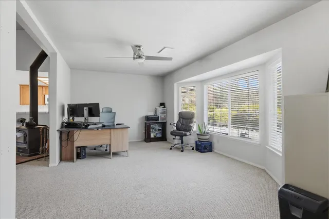 a view of a livingroom with furniture and a window