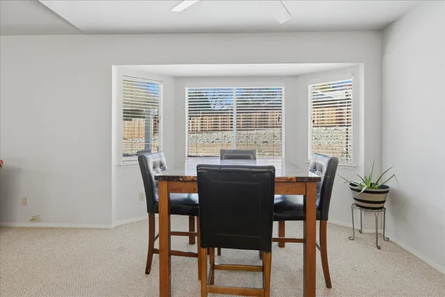 a view of a dining room with furniture and window