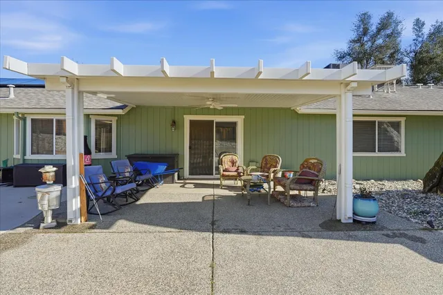 a view of a chairs with potted plants in front of house