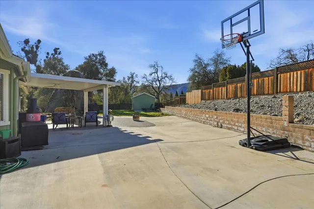 a view of a backyard with large trees