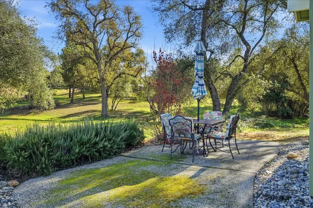 a view of a swimming pool with a table and chairs